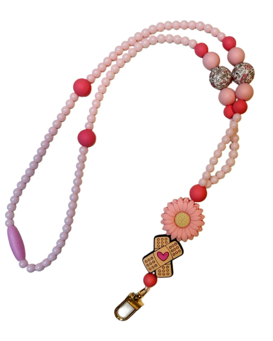 “Nurse Life” kortsnor – rosa blomster og plaster med hjerte